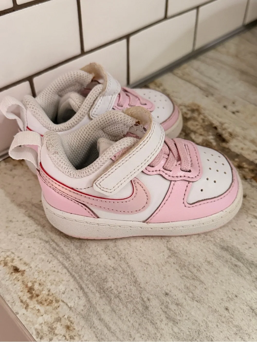Kids Pink and White Nike shoes
